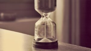 A glass hourglass with sand running through it